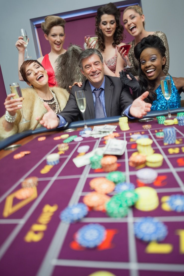 Live casino table dealer and roulette wheel in action